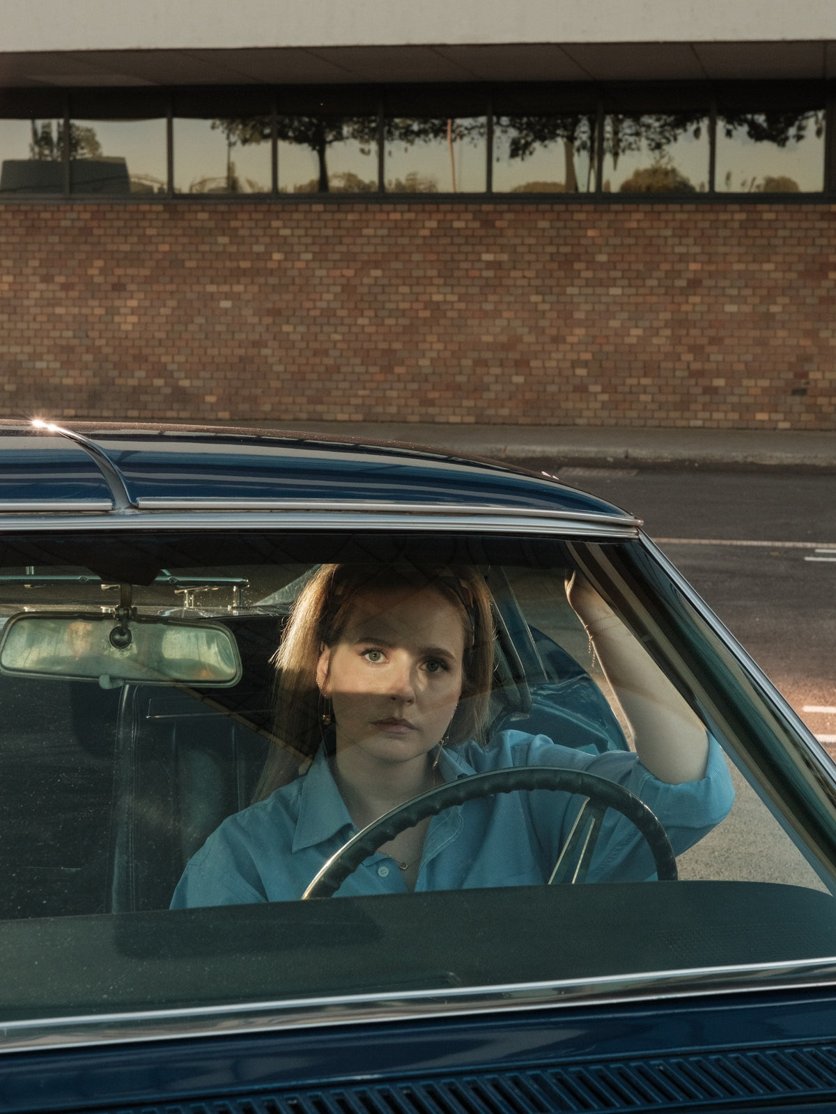 Woman behind the windshield of a vintage car