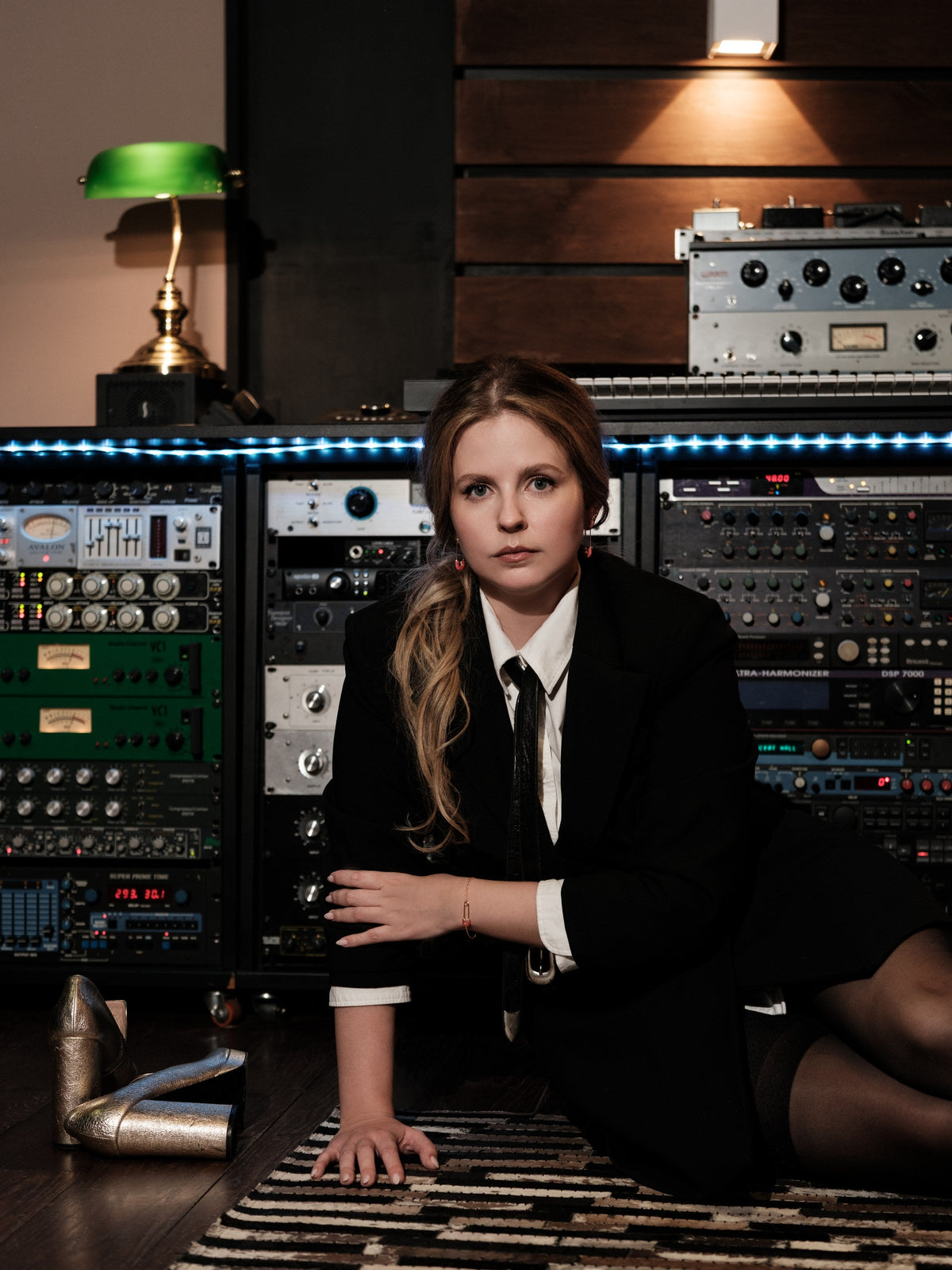 Woman in a black suit in a recording studio